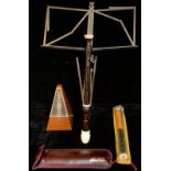 A metronome; two Aulos recorders and a folding music stand
