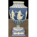 A 19th century Wedgwood Jasperware urnular vase, applied with a band of dancing muses in low relief,
