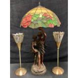A table lamp, the resin moulded support as a classical couple, "Tiffany" style glass shade, 81cm;