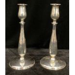 A pair of late 20th century Cartier sterling silver candlesticks, hollow weighted, number 377, 23.