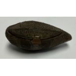 An African carved nut snuff box, hobnail cut in panels, 11cm wide, c.1900