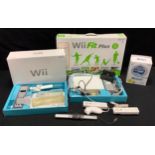 A Nintendo Wii with controllers, sports resort pack games & wii fit plus