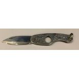 A sterling silver cigar cutter steel blade, the case chased and engraved with foliate scrolls,