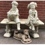 A decorative reconstituted stone model of a boy and girl, sat upon a bench, the supports modelled as