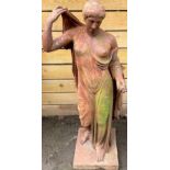 A cast iron garden stature, of a Greek lady, wearing flowing robes, holding a fruit, 128cm high