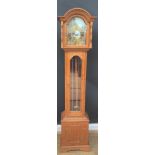 An oak short case hall clock, brass twin weights