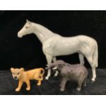 A Beswick model of an Elephant, trunk raised; a Beswick model of a Lion Cub; a Beswick model of a