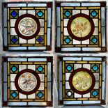 A set of four Arts and Crafts type late Victorian square stained glass window panels, two with