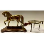 An early 20th century brass hearth ornament, as a horse; a Victorian lyre shaped trivet (2)