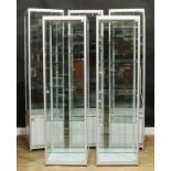 Five shop display cabinets or showcases, the largest 198cm high, 50cm square (5)
