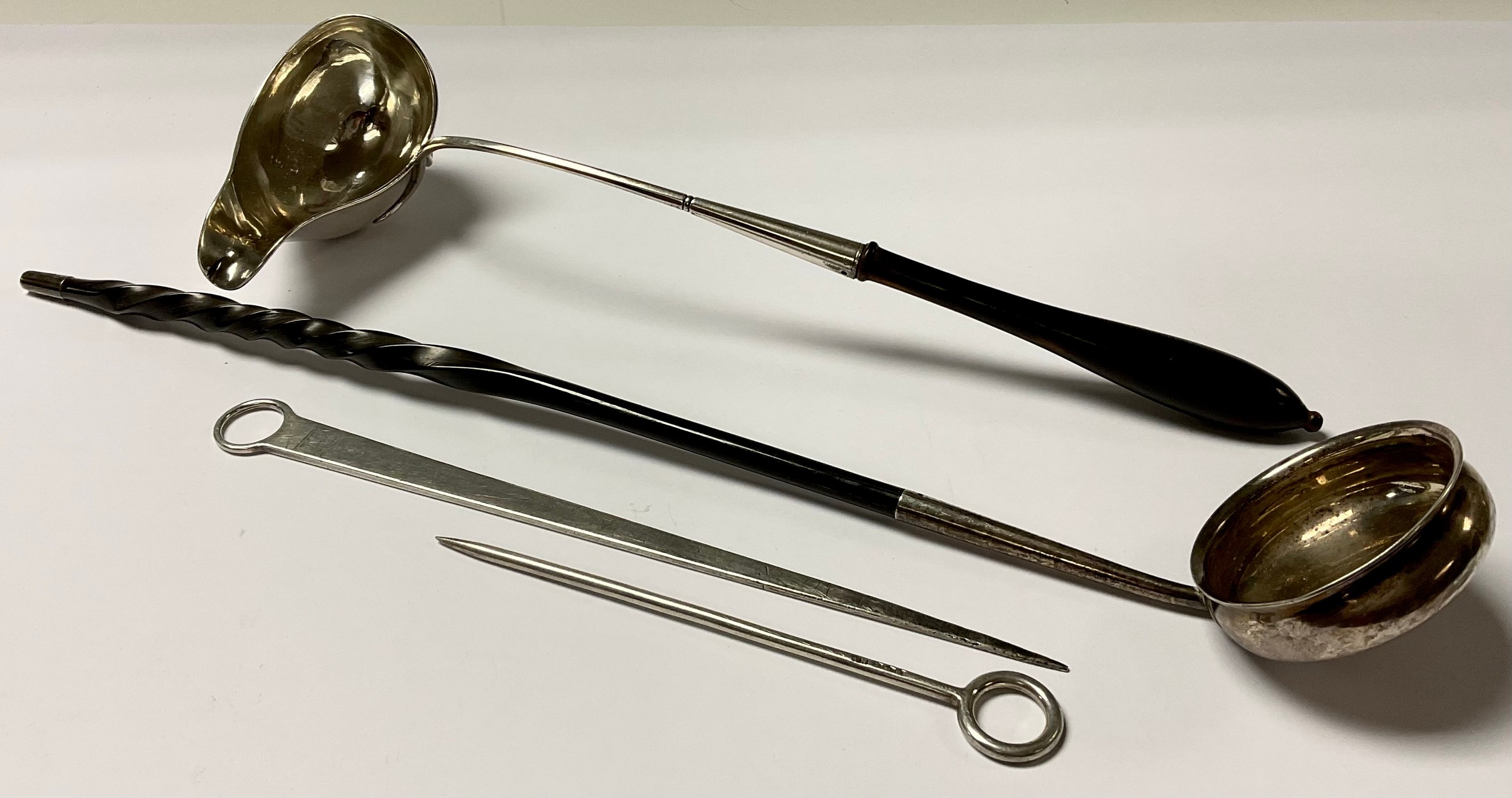 A Georgian silver coloured metal toddy ladle, baleen handle, 38.5cm long; another, Continental; a