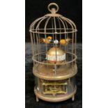 A reproduction novelty automaton clock, as a bird in a cage, approx. 18cm high over loop