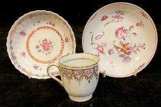 A late 19th century porcelain tea cup; two similar saucers, c.1800 (3)