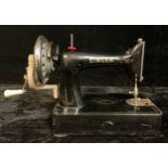 A Singer manual sewing machine, number 99K, original soft cover