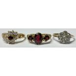 A 9ct gold ring, set with three garnets, size M, marked 375, 2.7g; a 9ct gold and silver paste