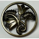 A silver circular openwork brooch, designed by Geoffrey G Bellamy, stylised tulips, George Tarratt