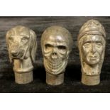 A bronzed cane walking stick handle, as the head of a man; others similar, a dog and a skull (3)