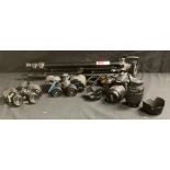 A Nikon D3300 DSLR camera; two pairs of binoculars, etc