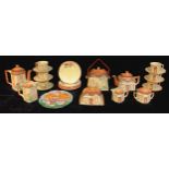 A Staffordshire English thatched cottage teapot, six cups, saucers and plates, biscuit barrel,