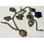 A late 19th century silver curb link Albert chain, T-bar, suspended with seven silver fobs,