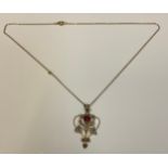 An Edwardian gold coloured metal, garnet and seed pearl pendant necklace