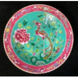 A Chinese Famille Rose circular dish, the centre field painted in polychrome enamels with an