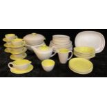 A Poole twintone lime yellow and seagull grey dinner and tea service, pattern number C103, including