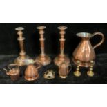 A 19th century copper flagon, 23cm; a pair of copper candlesticks gadrooned spreading circular