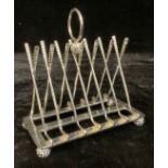 A plated novelty toast rack, the uprights modelled as crossed golf clubs, 16cm high