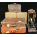 A late 19th/early 20th century leather suitcase, 61cm wide; a wooden bound suitcase/steamer trunk;