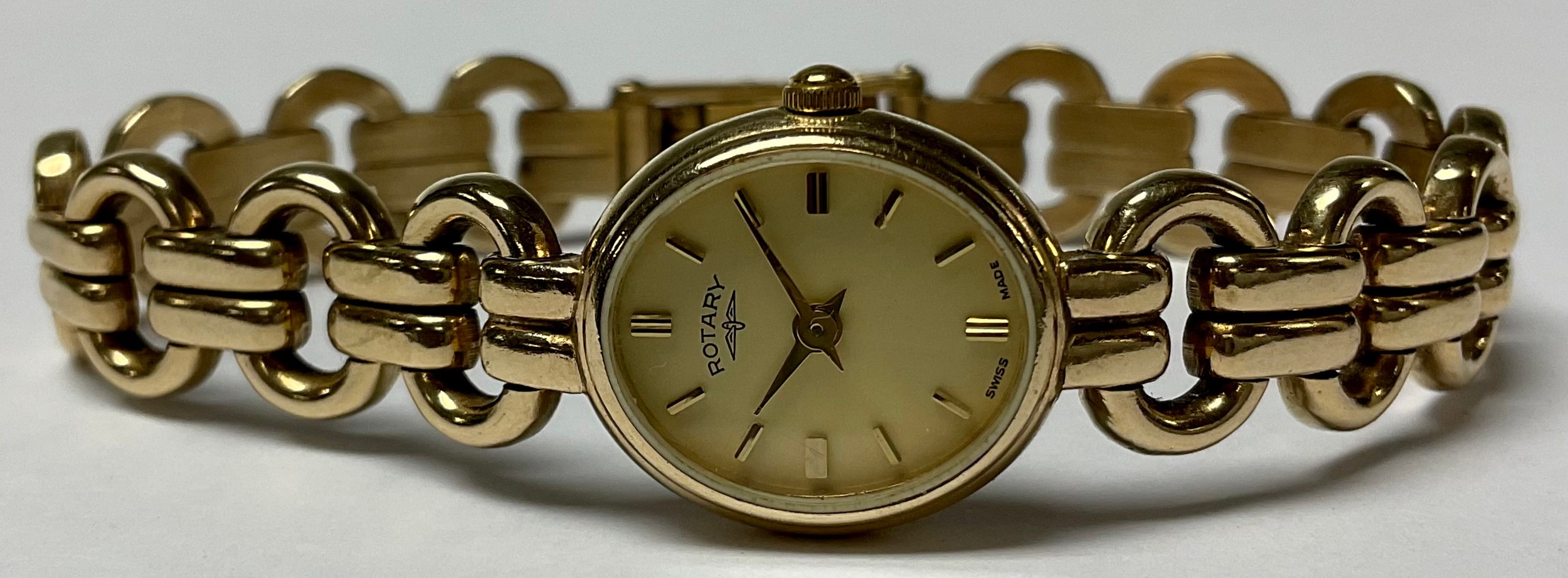 A 9ct gold lady's Rotary wristwatch, champagne dial, baton markers, side wind, articulated strap
