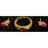 An 18k gold ruby and diamond three stone ring, size N/O, apparently unmarked, 4.3g, with certificate