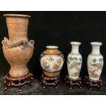 A Chinese style terracotta two-handled vase, moulded in relief with a dragon, hardwood stand, 62cm