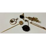 A 15ct gold peridot and seed pearl bar brooch, 3g; an unmarked horse shoe pin set with seed