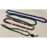 A Lapiz Lazuli bead necklace; a malachite bead necklace; another; an agate bead necklace (4)