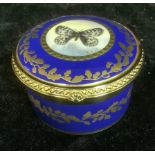 A Lynton porcelain circular table box, painted by Stefan Nowacki, signed, with a butterfly, within a