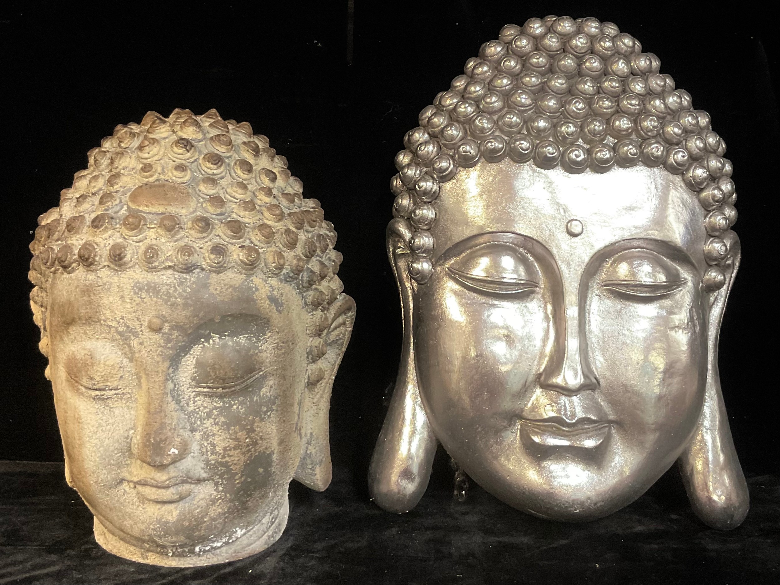 Interior Decoration - a large rustic head of a Buddha, 44cm high; a silver coloured buddha wall