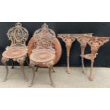 A pair of 19th century heavy cast iron garden chairs, in the manner of Coalbrookdale, and a