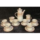 A Tony Grant Studio pottery coffee service comprising hot water pot, cups, saucers, milk jug; etc