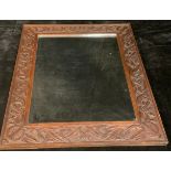 An Arts and Crafts rectangular carved oak looking glass, plain mirror plate, 65cm x 55cm