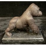 A bronzed metal sculpture of a gorilla, rectangular stepped marble base, 18cm high