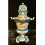 A Continental porcelain vase and cover, decorated with putti, blue ground picked out in gilt