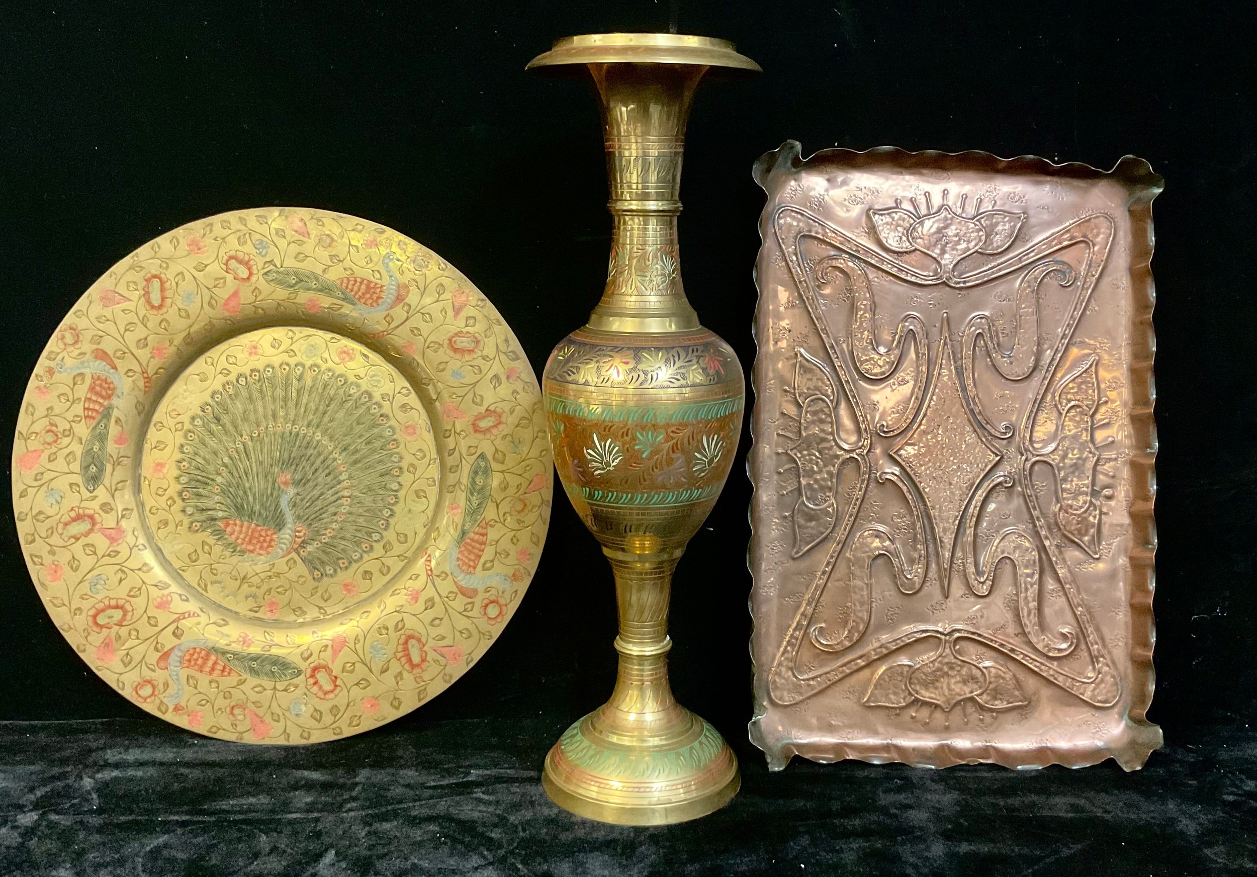 An Arts and Crafts rectangular copper tray, embossed with stylised sinuous flowers, pie crust raised