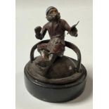 A cast metal model of a monkey, smoking a pipe and reading, 7cm high