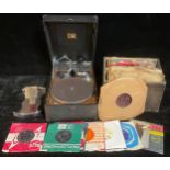 A table top wind up HMV (His Master's Voice) gramophone, a selection of 78s, some 45s