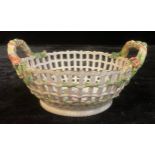 A Berlin two handled basket, painted with flowers, pierced sides, rustic handles, 23cm diam, KPM