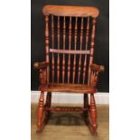 A country cottage rocking chair, 104.5cm high, 57cm wide, the seat 39cm wide and 34cm deep