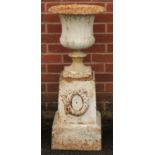 A 19th century cast iron campana shaped garden urn and plinth, egg-and-dart rim, the plinth cast and