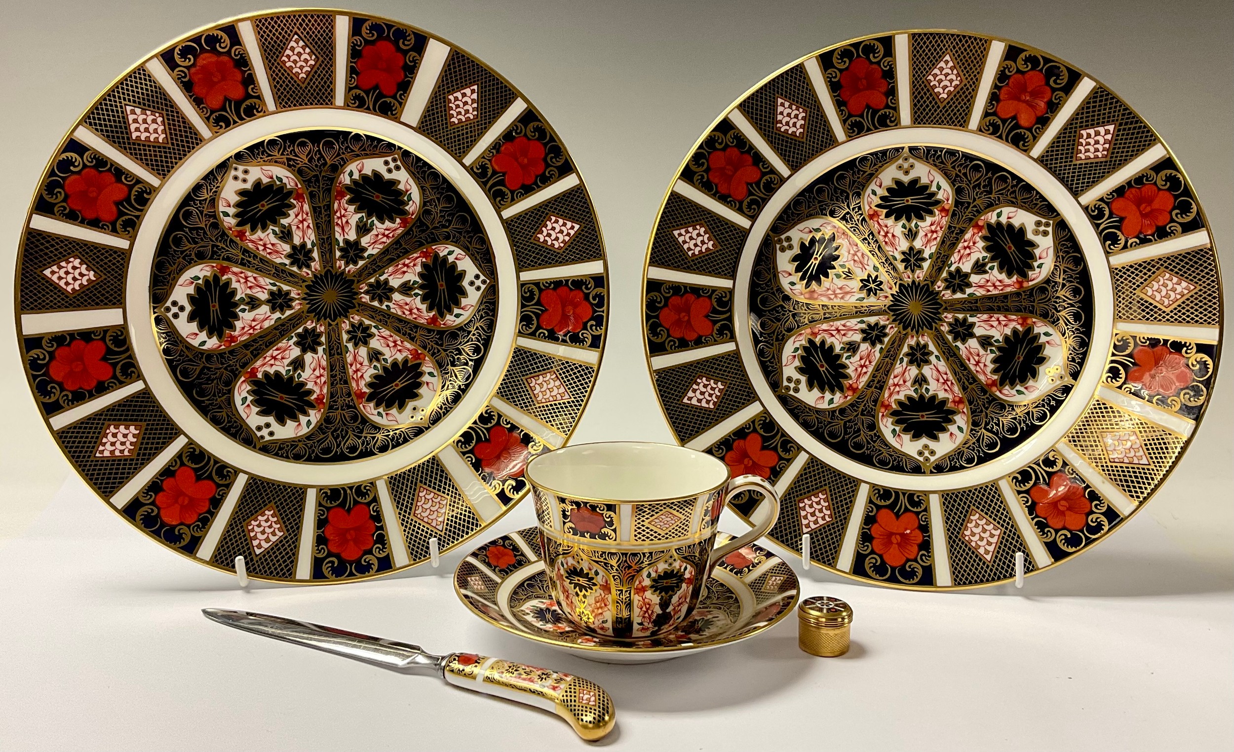 A pair of Royal Crown Derby Imari palette 1128 pattern dinner plates, seconds; an 1128 patern teacup