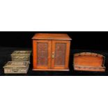 An Edwardian oak smoker's cabinet, moulded top, pair of fielded carved doors, brass escutcheon,